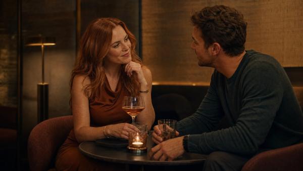Adult couple sharing an attentive conversation at a small cocktail table